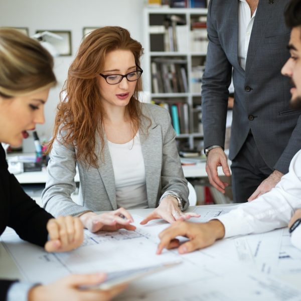 Group of business people collaborating in office Group of business people collaborating in office